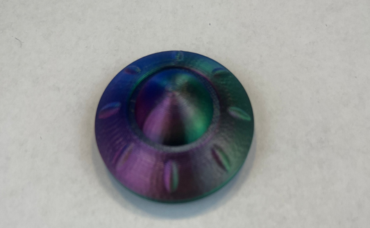 Multicolored metallic object on a white background