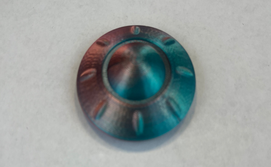 Metallic blue and copper-colored knob on a light gray background