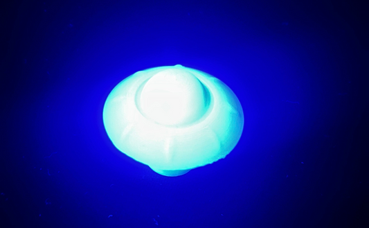 Blue glowing orb-like object against a dark background