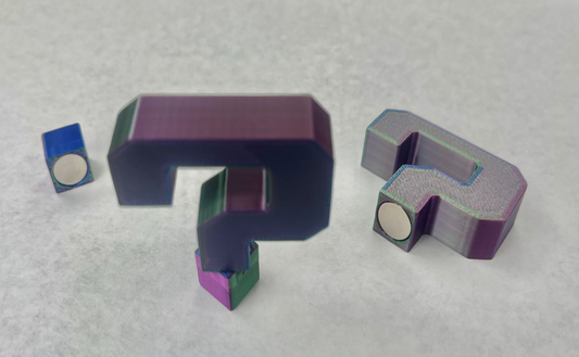 Magnetic question mark-shaped hat brim pins in various colors.
