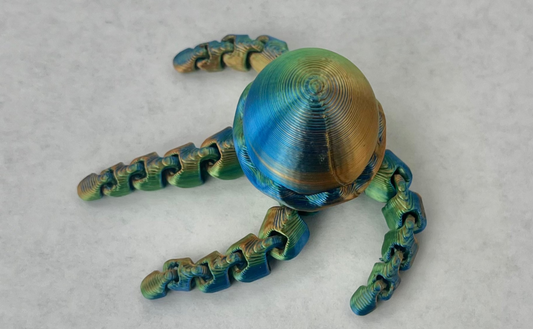 A multicolored metallic magnetic jellyfish hat brim accessory.